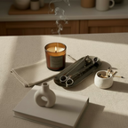 A fun-size candle next to a 3-piece accessory set including a candle snuffer, wick trimmer, and candle tray, with the KEO brand visible on the tray.