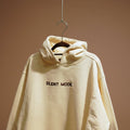Beige oversized hoodie with 'SILENT MODE.' embroidered on the front and brand logo on the back.